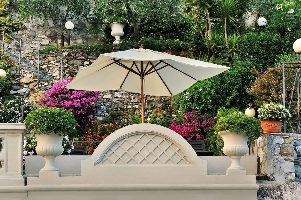 white umbrella in the garden surrounded with flowers, Plant Shade Umbrellas