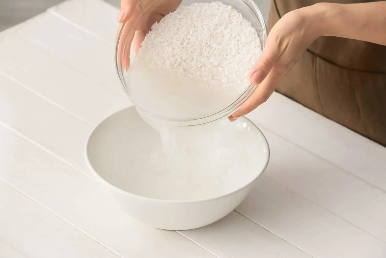 Woman-preparing-rice-water-on-the-table