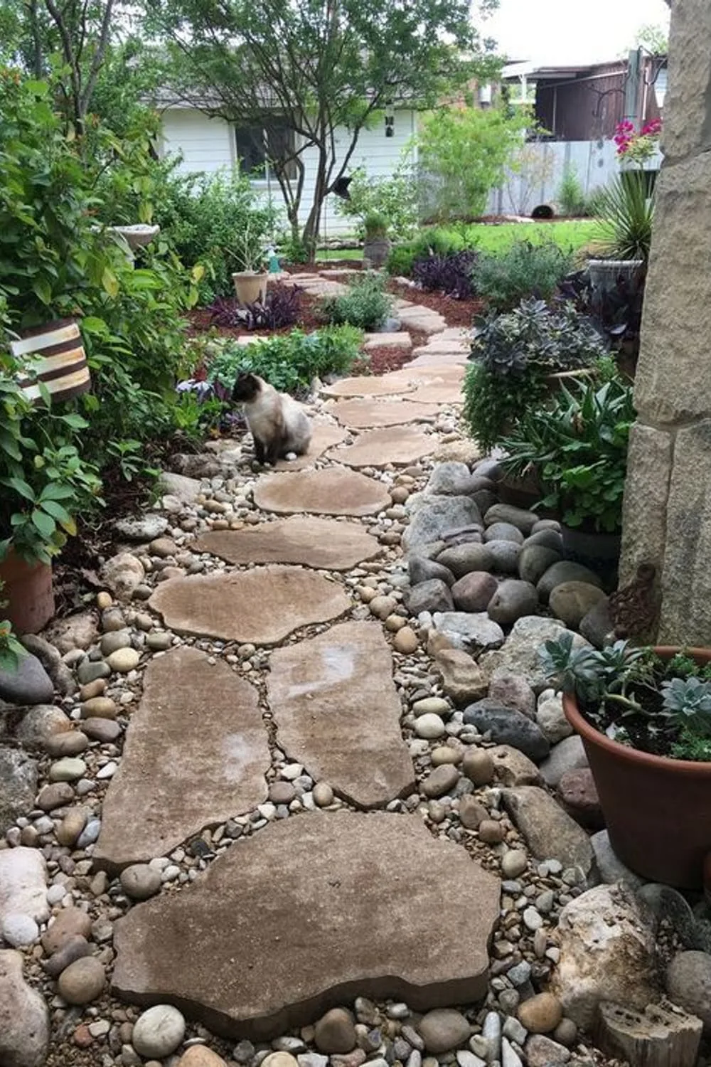 a natural and rustic garden path of larger stones and smaller pebbles  around looks cool and chic - DigsDigs